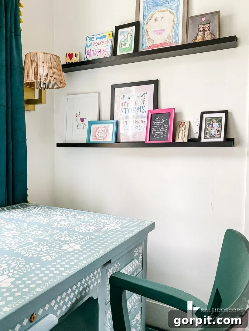 Organized colorful art on photo ledges in home office