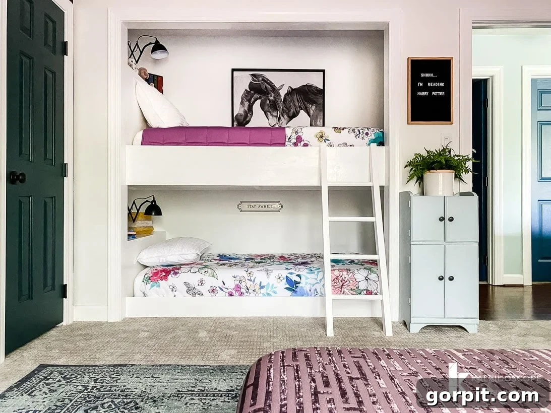 A girl's bedroom with built-in bunkbeds in a closers nook. 
