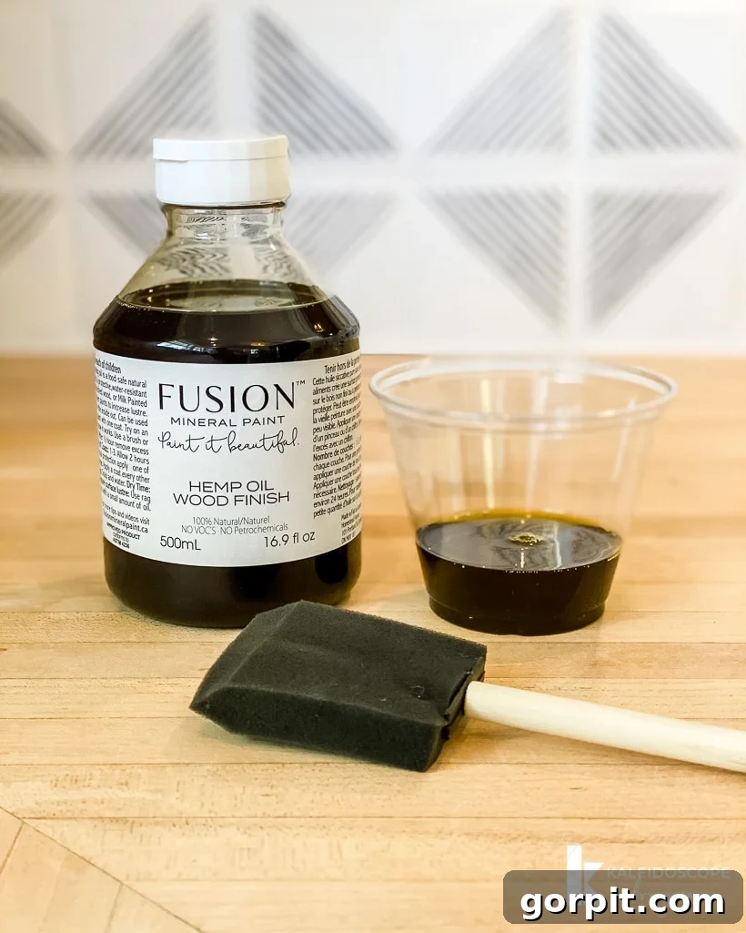 applying hemp oil to butcher block countertops with a foam brush