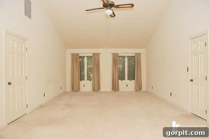 Before photo of a beige master bedroom with carpet