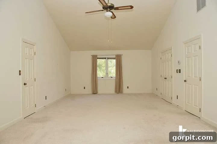 Another before photo of the master bedroom, showing old carpet and beige walls