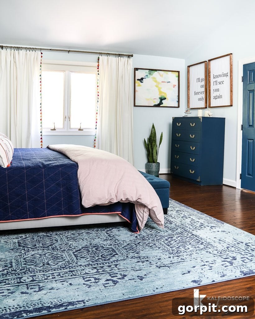 Elegant colorful master bedroom with a tall dresser and meaningful artwork
