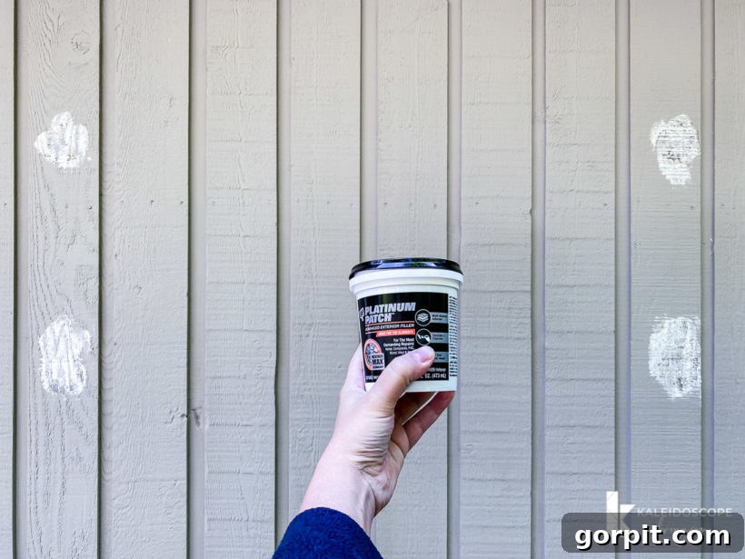 Close-up of patched and filled areas on a house exterior before painting