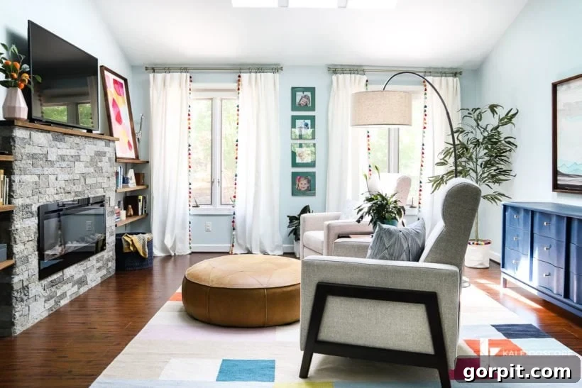 Beautifully decorated living space with windows adorned by white curtains featuring vibrant, colorful tassel trim, enhancing the room's aesthetic.