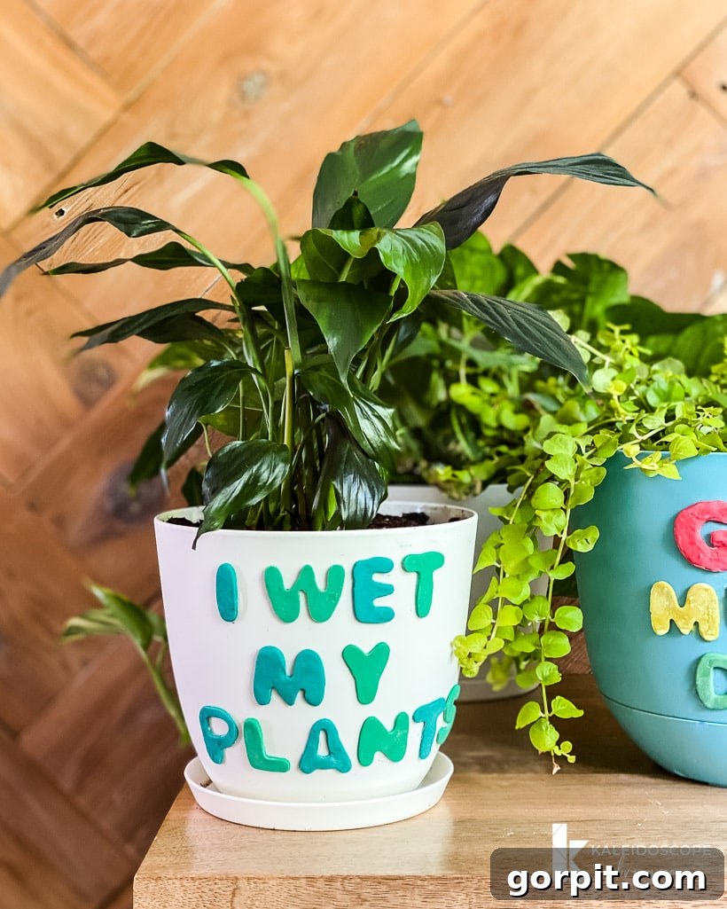 Close-up of a white plant pot with colorful polymer clay designs