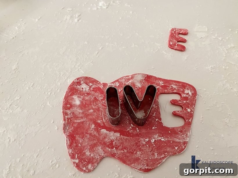 Various polymer clay shapes and letters cut out using cookie cutters