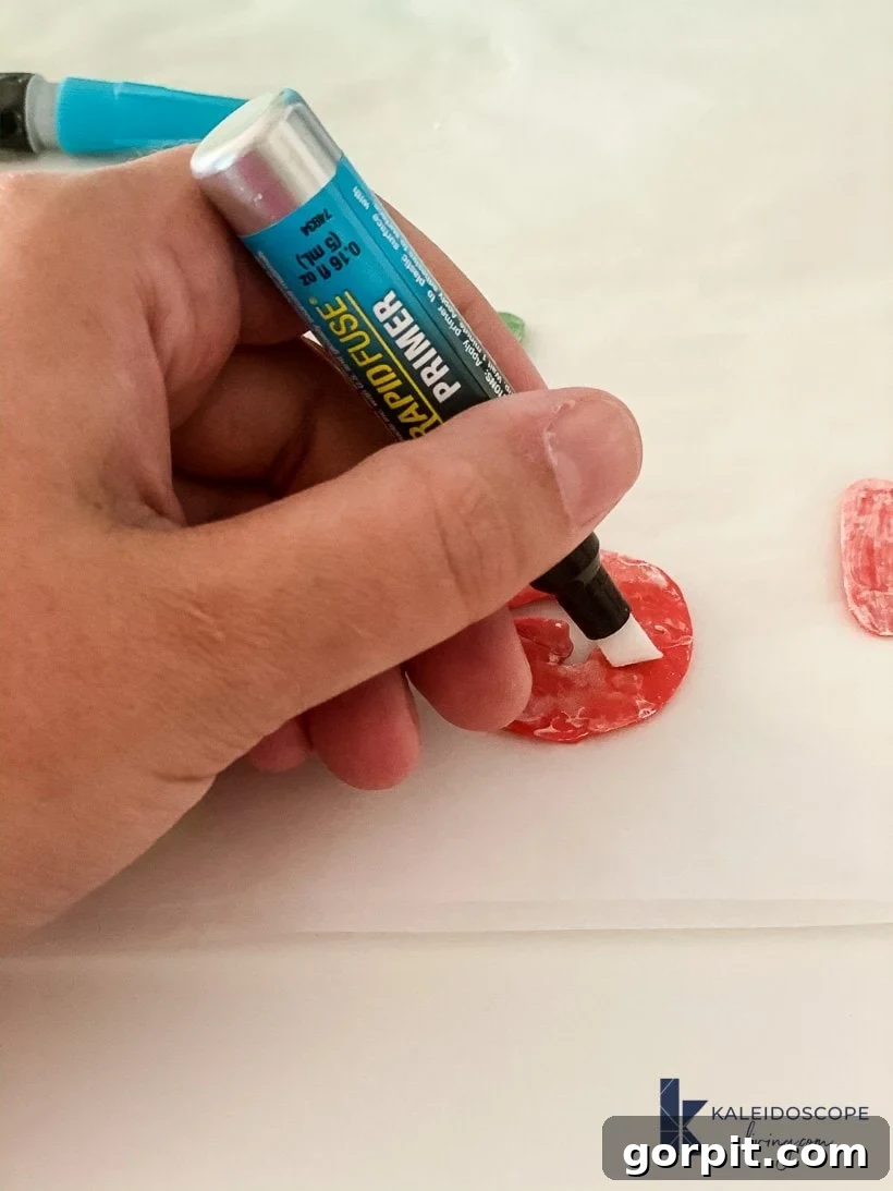 Applying DAP plastic primer to the back of a polymer clay shape
