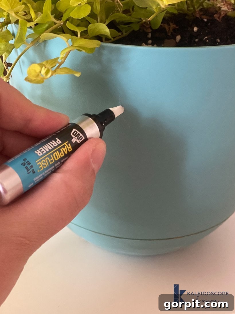 Applying DAP plastic primer to the plastic plant pot surface