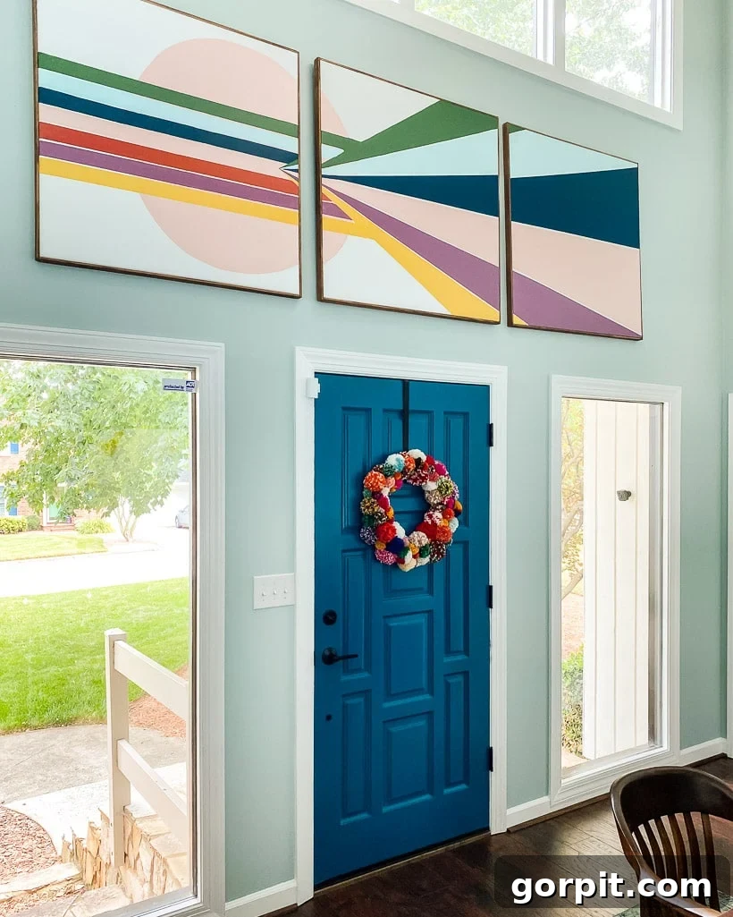 A Burst of Summer: My Colorful Home Unveiled 9 Close-up of a colorful DIY pom-pom wreath hanging in a foyer, adding a playful and year-round festive touch.