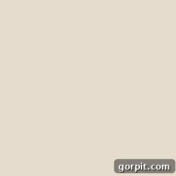 Paint swatch for Sherwin-Williams Divine White, an elegant off-white interior trim color option.