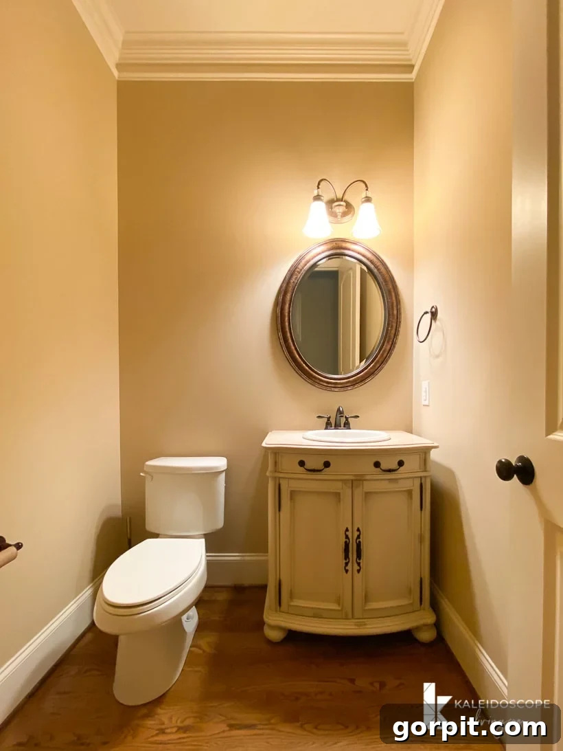 Our New House: The Starting Point Tour Part 1 26 Powder room with a simple vanity, mirror, and wood flooring.