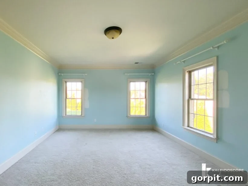 Attley's bedroom before renovation, showing blue walls and natural light.