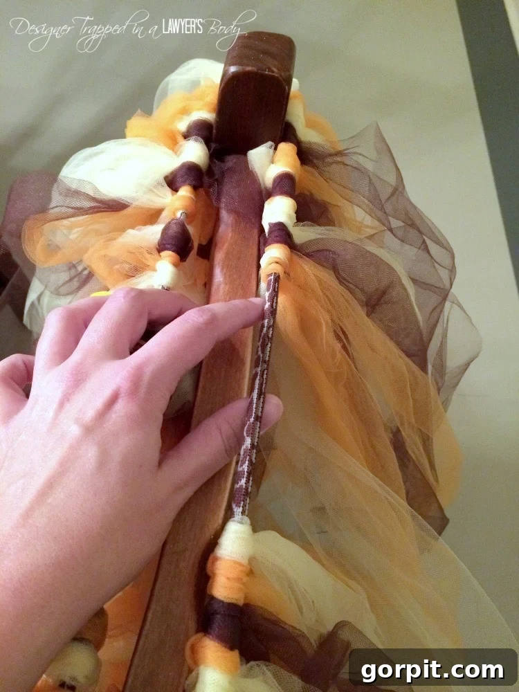 Scarecrow tutu in progress, showing tulle being tied onto an elastic band stretched over a chair.