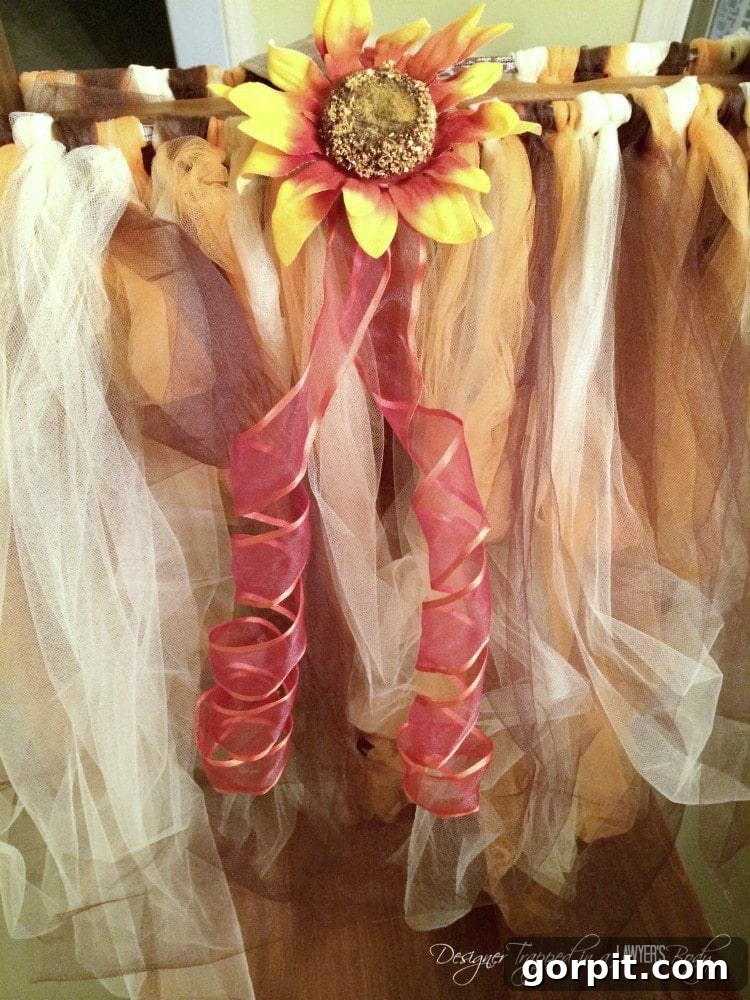 Close-up of attaching a sunflower and chiffon ribbon to the front of a scarecrow tutu costume.