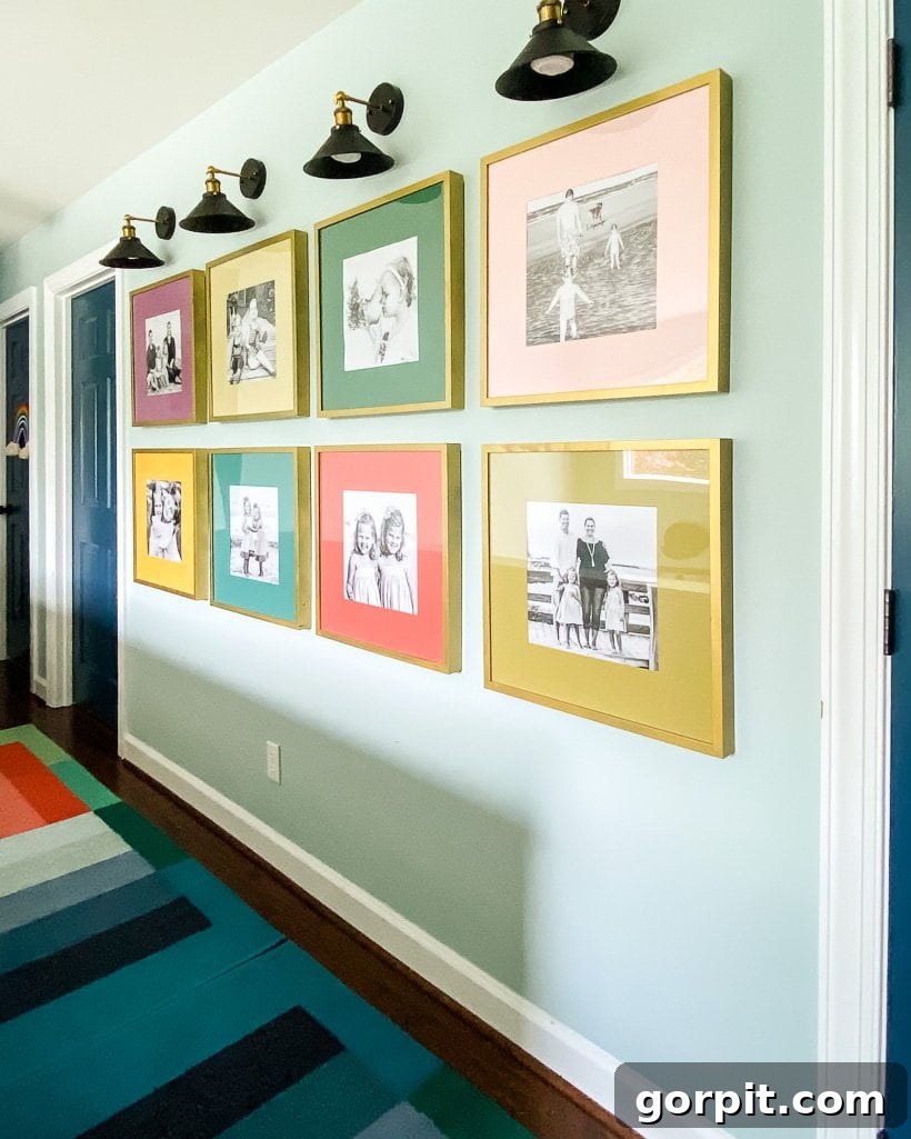 The Art of Grand Scale Elevate Your Home with Oversized Decor and Sourcing Secrets 7 A vibrant hallway gallery wall showcasing a collection of colorful family photos in various frames.