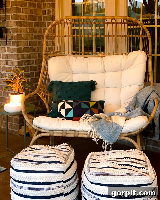 The comfortable egg chair on the screened-in porch illuminated at night, offering a cozy retreat.