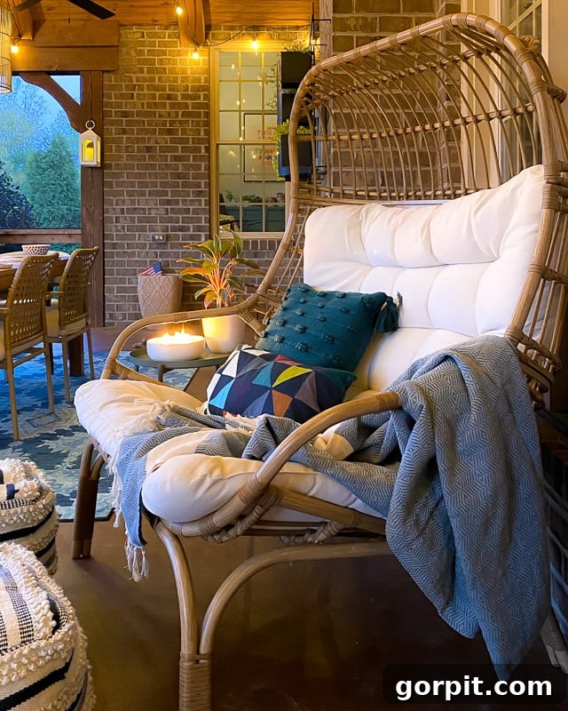 A panoramic view of the screened-in porch at night, emphasizing the enchanting glow of multiple light sources.
