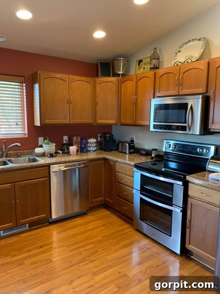 Before: Traditional kitchen with light wood cabinets and a basic layout, lacking modern appeal.