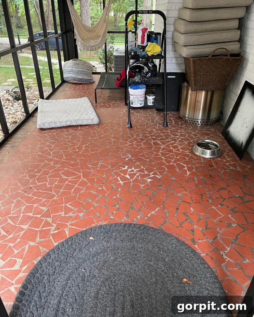 Before: Outdated screened-in porch with a plain, uninspired floor, lacking character.