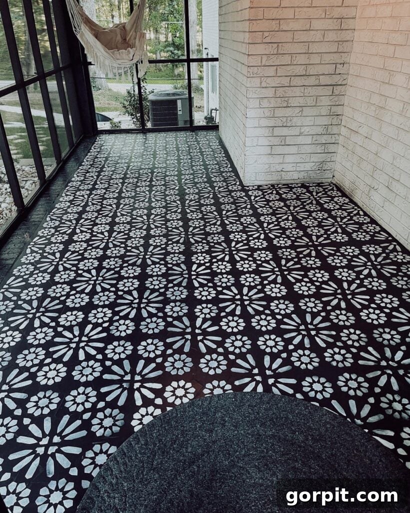After: Beautifully transformed screened-in porch featuring a painted and stenciled floor, creating a stylish and inviting outdoor area.
