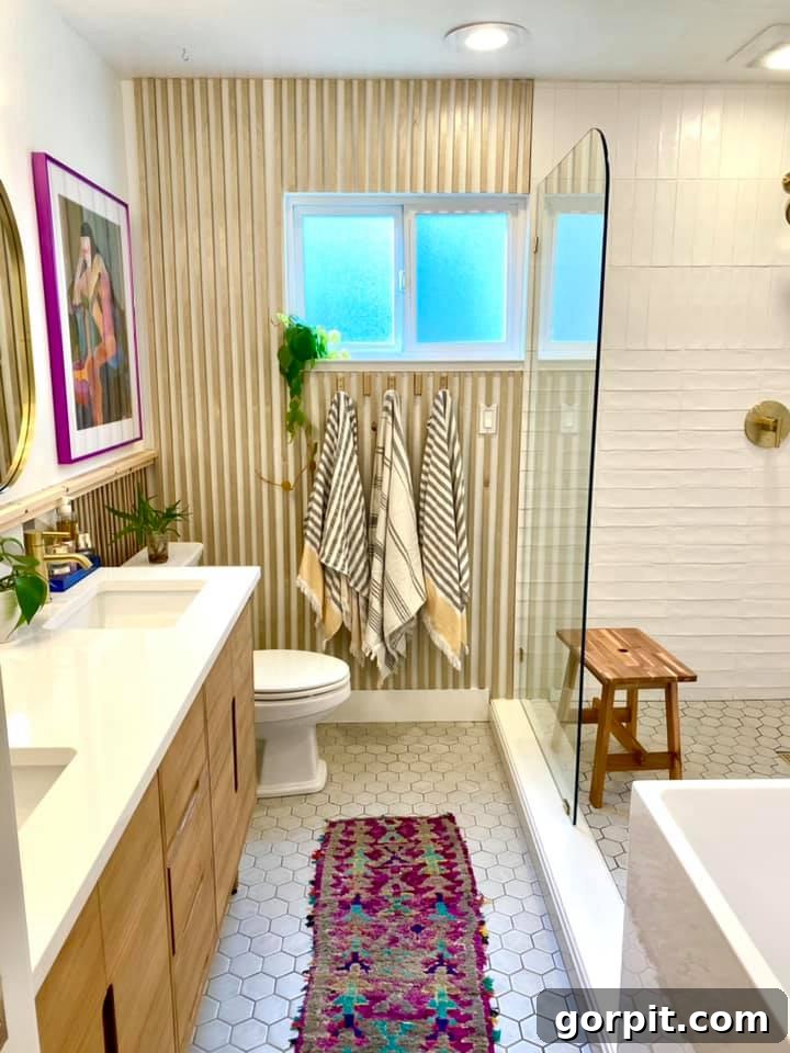 After: Modern and elegant bathroom with updated vanity, lighting, and decor, maintaining the original layout for cost-effectiveness.