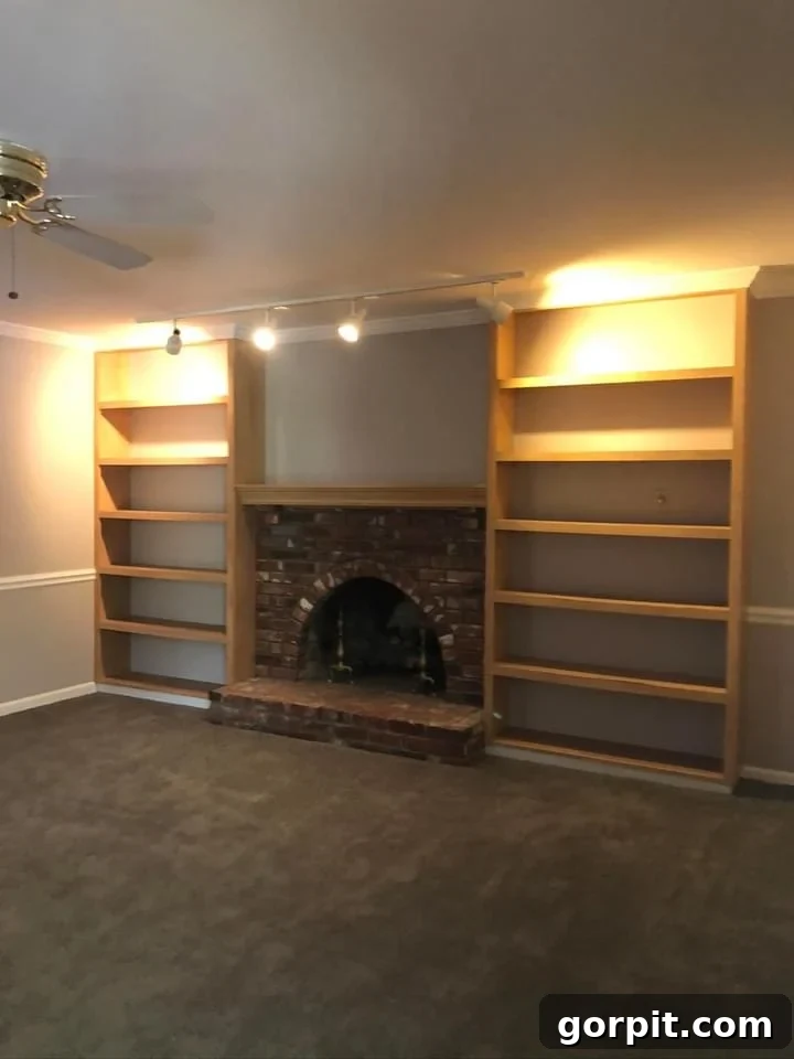 Before: Dated family room with traditional fireplace and furnishings, lacking modern appeal.