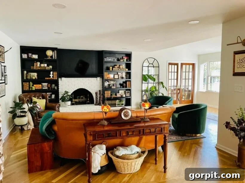After: Modern and elegant family room with updated fireplace, fresh color scheme, and contemporary furnishings, achieved without demolition.