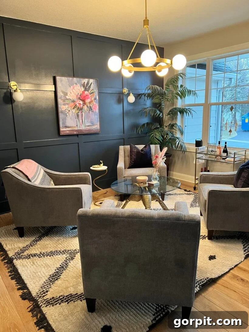 After: Elegant lounge featuring stylish board and batten walls, a chic light fixture, and a cohesive color palette, creating a sophisticated ambiance.