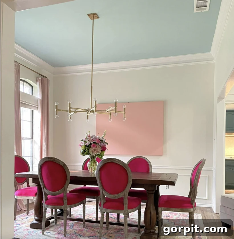 After: Vibrant and elegant dining room featuring a beautiful pink color palette, stylish furniture, and refined decor, creating a welcoming and personalized space.
