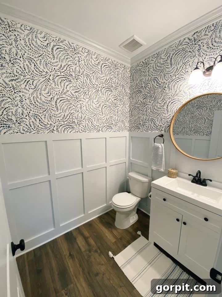 After: Elegant neutral bathroom with white board and batten walls and sophisticated patterned wallpaper, showcasing texture and depth.