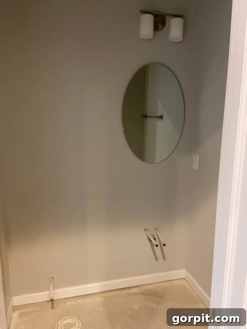 Before: Bare half-bathroom with plain white walls and basic fixtures, serving as a blank canvas.