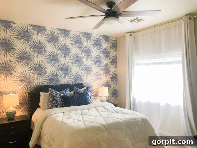 After: Transformed bedroom featuring stunning patterned wallpaper, vibrant colors, and curated decor, creating a unique and stylish sanctuary.