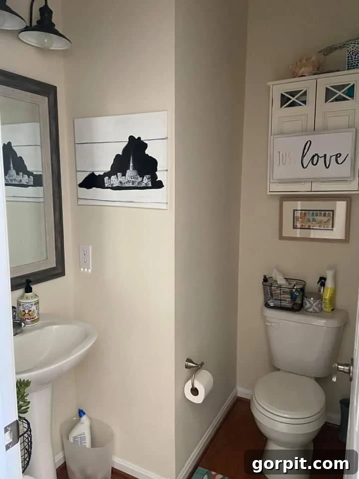 Before: Plain white powder room with standard finishes, lacking distinct style.
