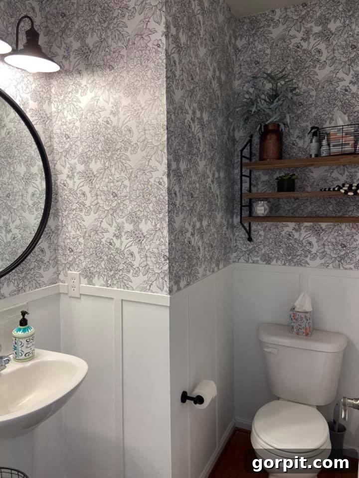 After: Stylish neutral bathroom featuring peel-and-stick wallpaper and DIY board and batten walls, creating an elegant and refreshed space.