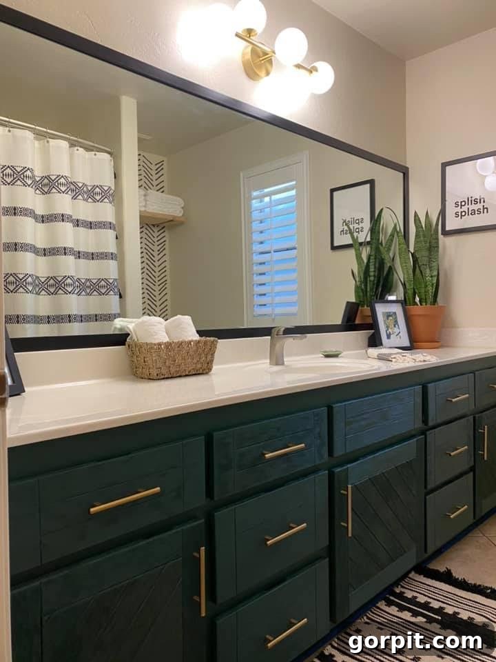 After: Bright and modern kids' bathroom renovation with a freshly painted vanity, updated fixtures, and a DIY mirror frame, creating a cheerful space.