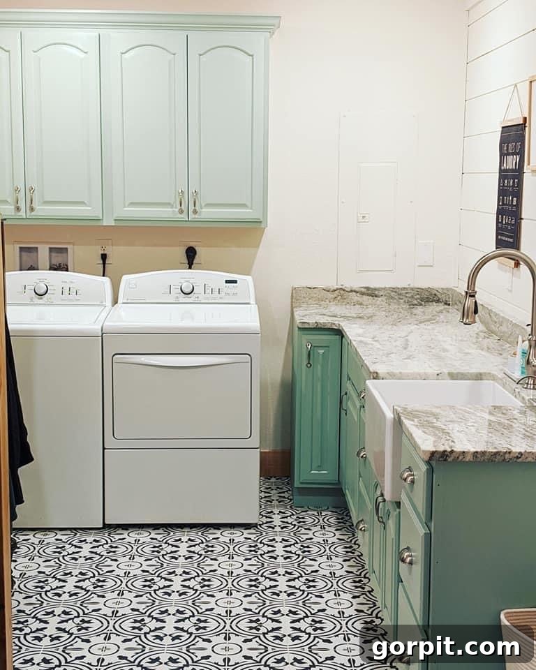 After: Bright and refreshed laundry room makeover with painted light cabinets, a new countertop, and updated decor, creating a fresh and inviting space.