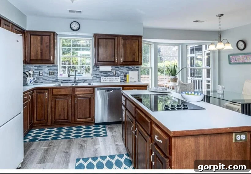 Before: Dated kitchen with dark wood cabinets and a traditional backsplash, appearing dim and uninviting.