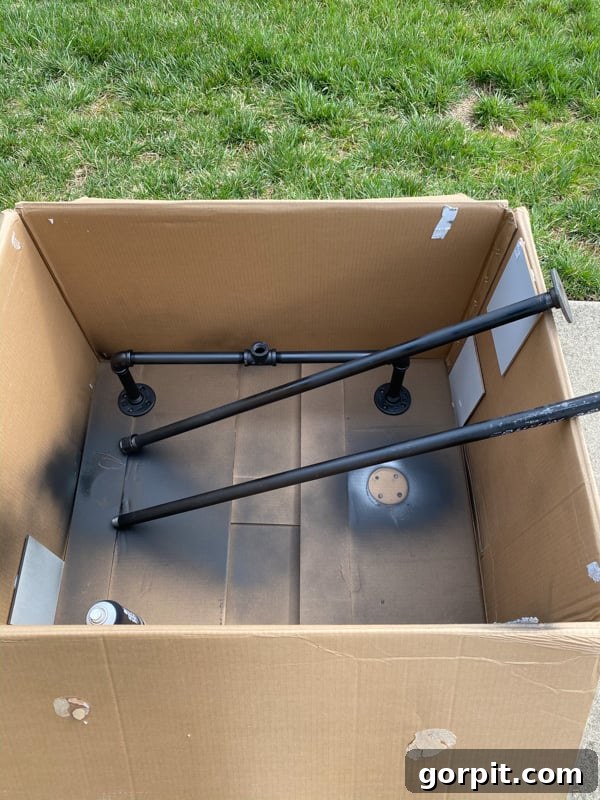 Craft Your Own Outdoor Chandelier 6 image of pieces of gas pipe in a box to contain overspray from spray