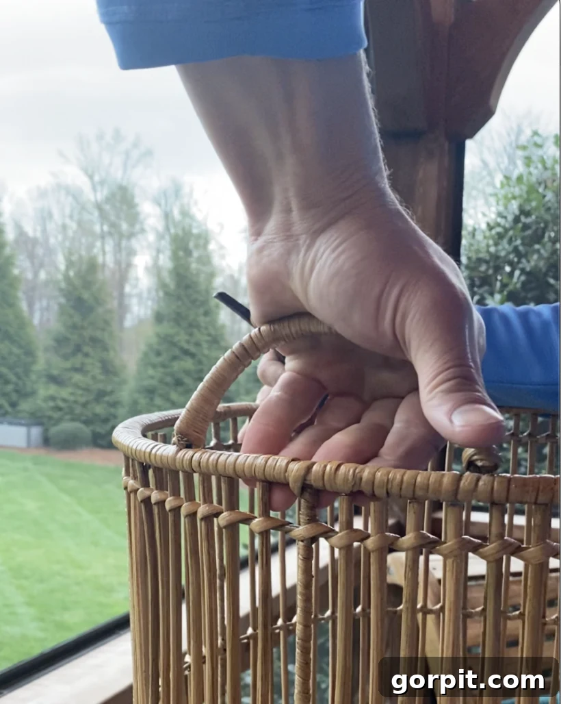 Craft Your Own Outdoor Chandelier 8 Image of man removing handles from woven rattan basket