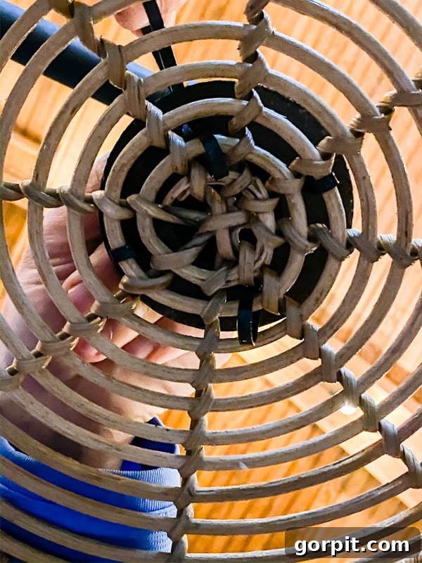 Craft Your Own Outdoor Chandelier 10 image of zip ties securing floor flange to basket while making DIY outdoor chandelier