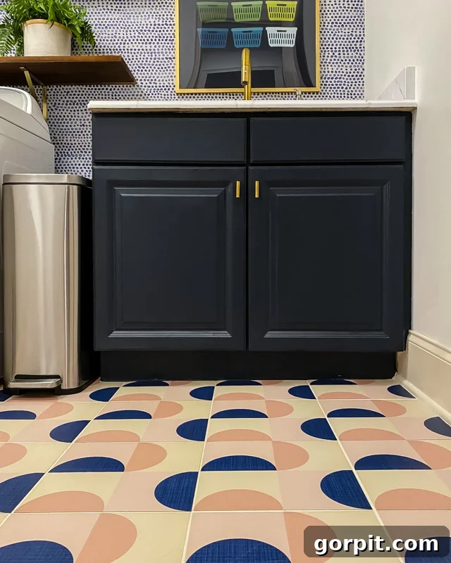 updated laundry room with stylish wallpaper and sink area