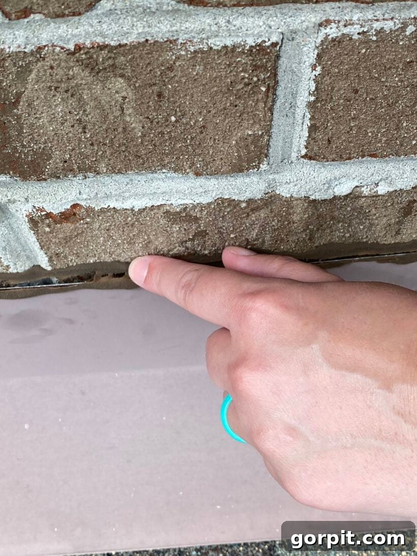 Failed seal along roof flashing indicating a potential leak point