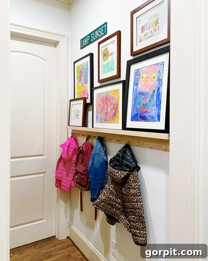Small Art Big Style Your Guide to Decorating 13 Stylishly decorated mudroom with a blend of small art on a ledge and hanging
