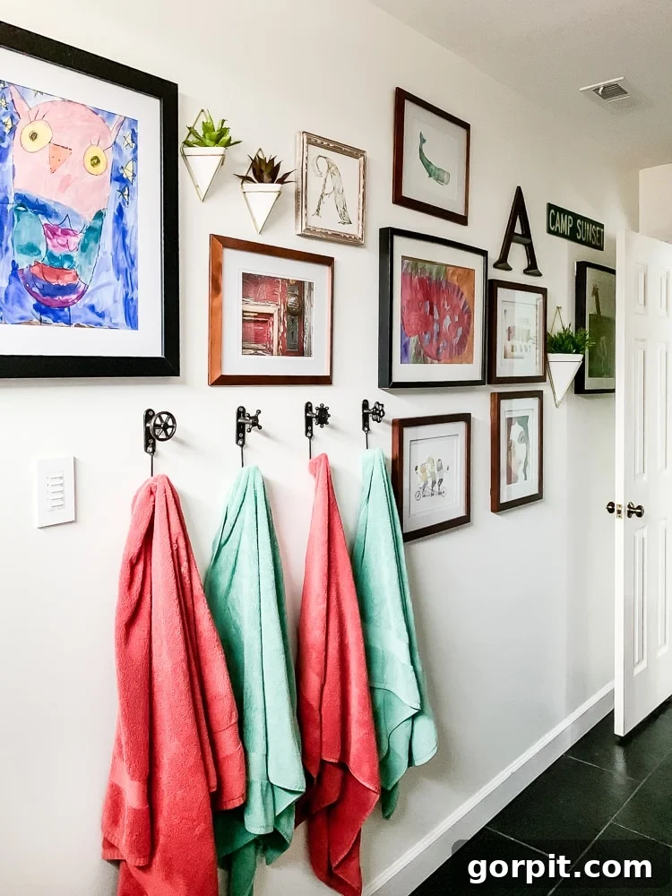 Small Art Big Style Your Guide to Decorating 7 Colorful gallery wall in a child's bathroom featuring personal and curated art