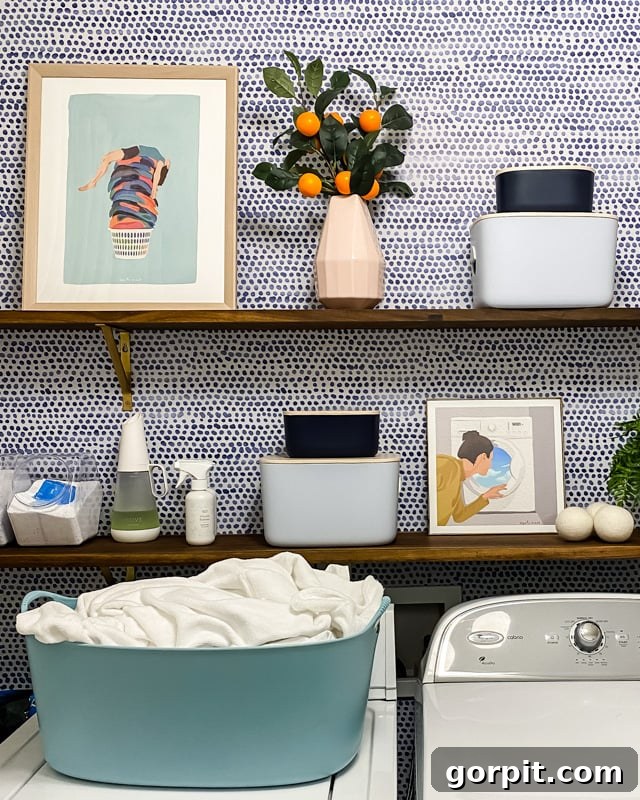 Styled open shelves with decorative elements and small art in a laundry room