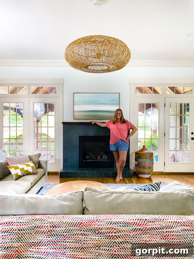 Stunning renovated fireplace with teal blue double herringbone tile and a modern white mantel