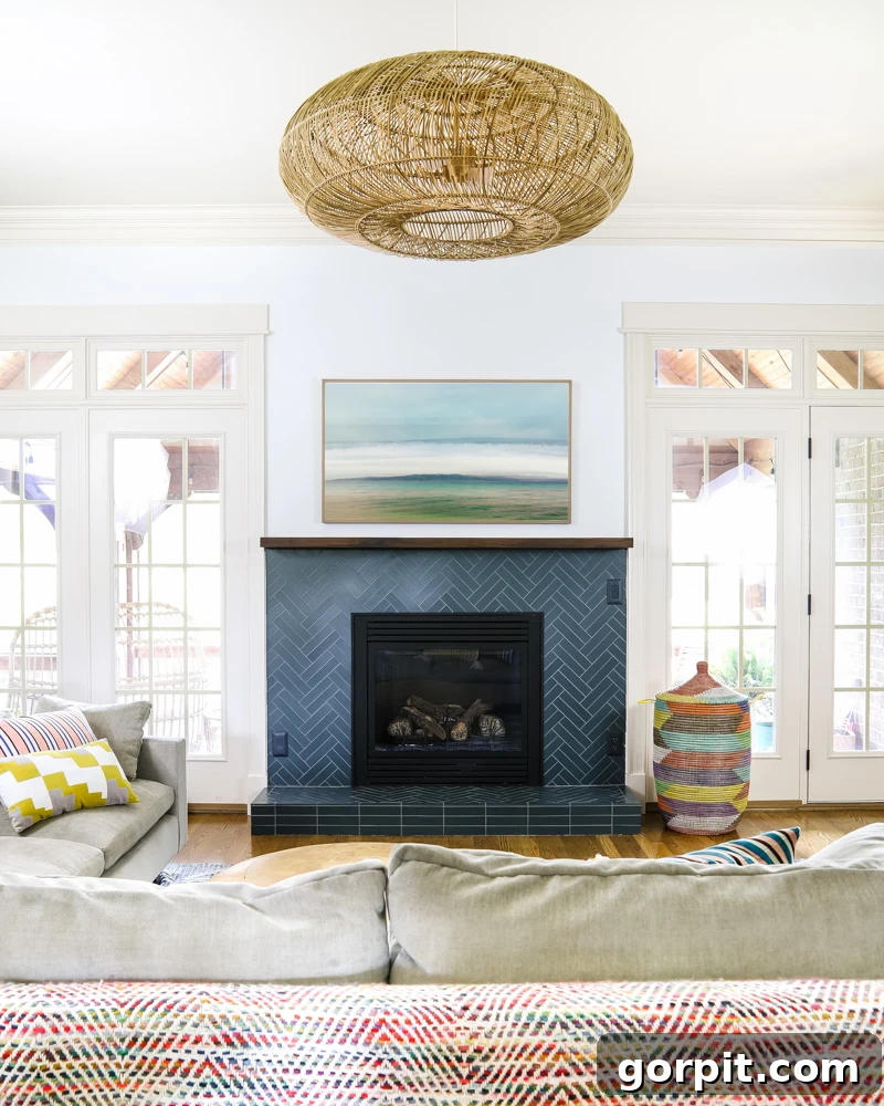 Cozy family room featuring the new teal herringbone tile fireplace, showing integrated outlets