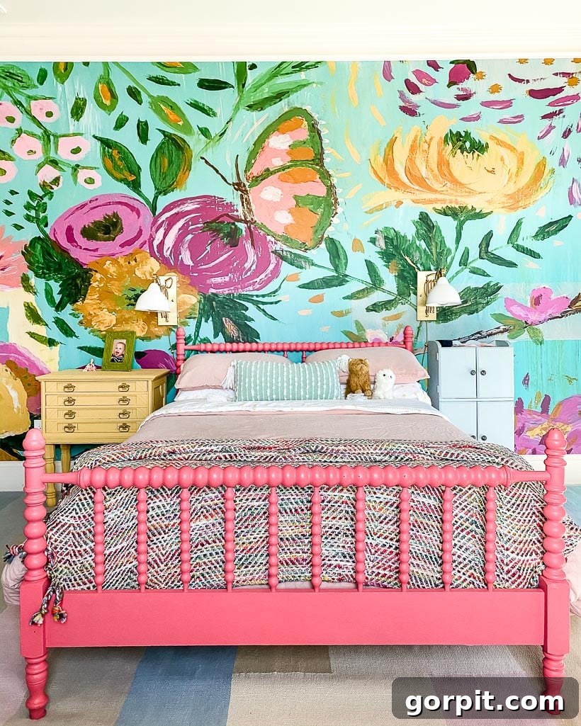 Colorful girls' room with painted furniture, flowered wall mural and colorful bedding.