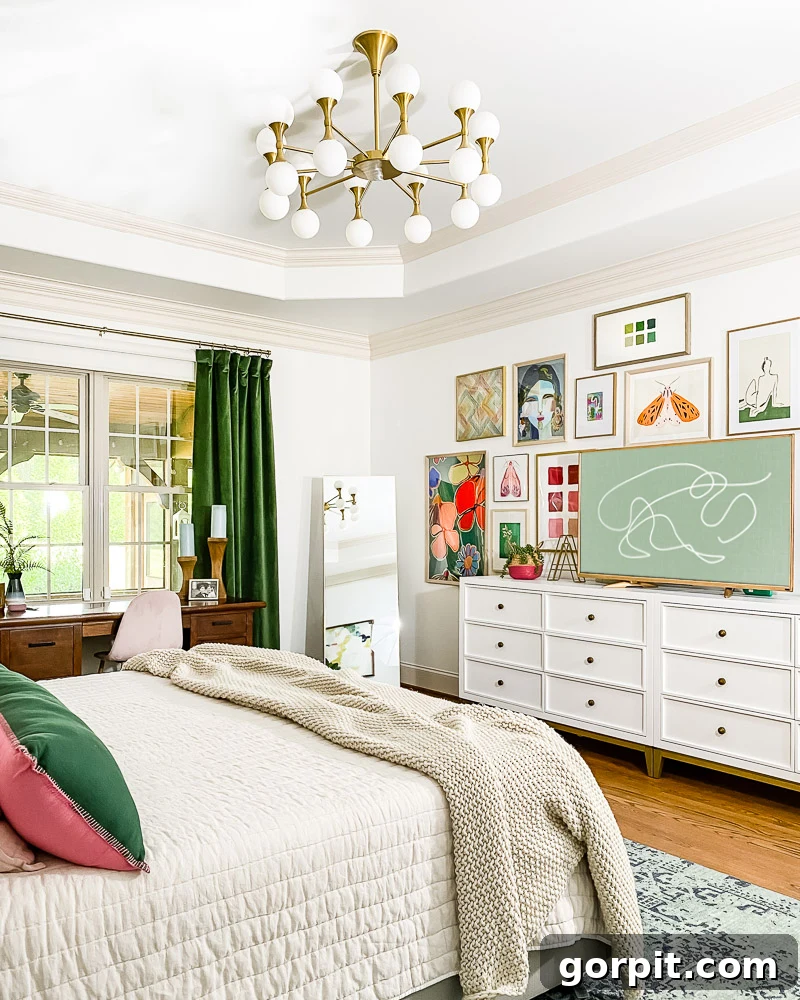 Updated bedroom with white dressers and gallery wall