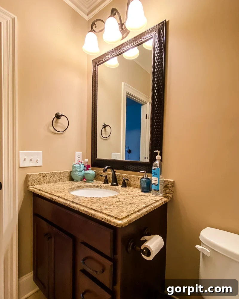 Avery Transforms A Bathroom For Less 4 Close-up of outdated brown bathroom vanity before renovation